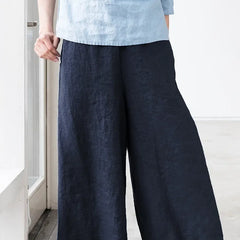Linen cropped wide-leg drawstring trousers for women by Christine Brewer, featuring a loose fit and comfortable pull-on style.
