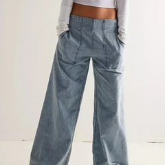 Blue denim wide-leg relaxed women's jeans by Christine Brewer, showing the fit and casual style of the pants.