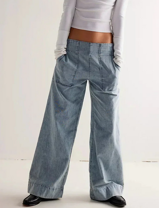 Blue denim wide-leg relaxed women's jeans by Christine Brewer, showing the fit and casual style of the pants.