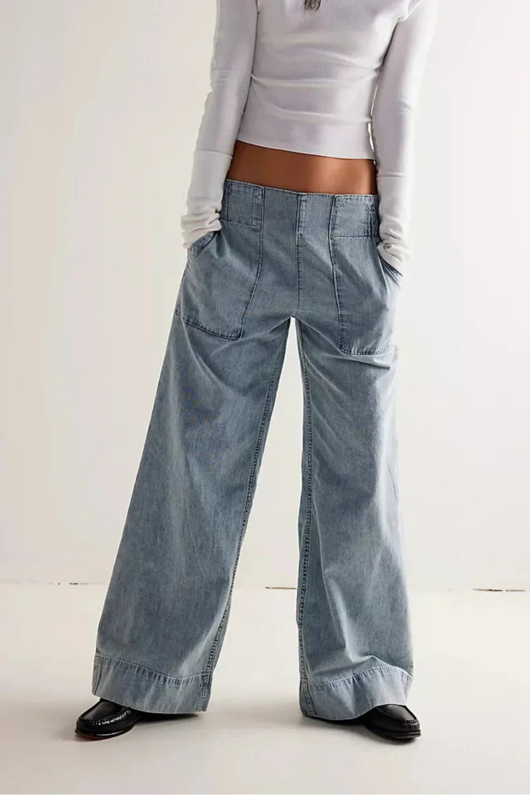 Blue denim wide-leg relaxed women's jeans by Christine Brewer, showing the fit and casual style of the pants.