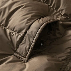 Long hooded parka for women by Christine Brewer, featuring a stylish design with a hood and warm fabric for cold weather.