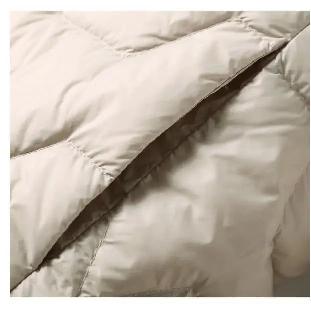 Women’s quilted puffer jacket with hood by Christine Brewer, featuring a stylish, insulated design perfect for cold weather.