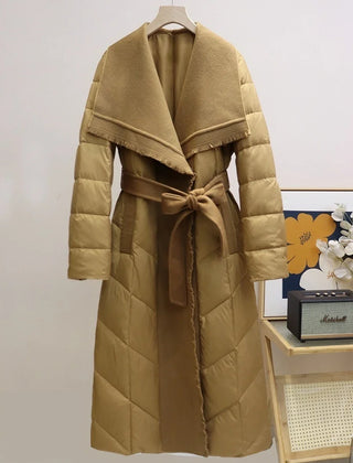 Long belted puffer jacket for women by Christine Brewer, featuring a quilted design and cozy, insulated style.