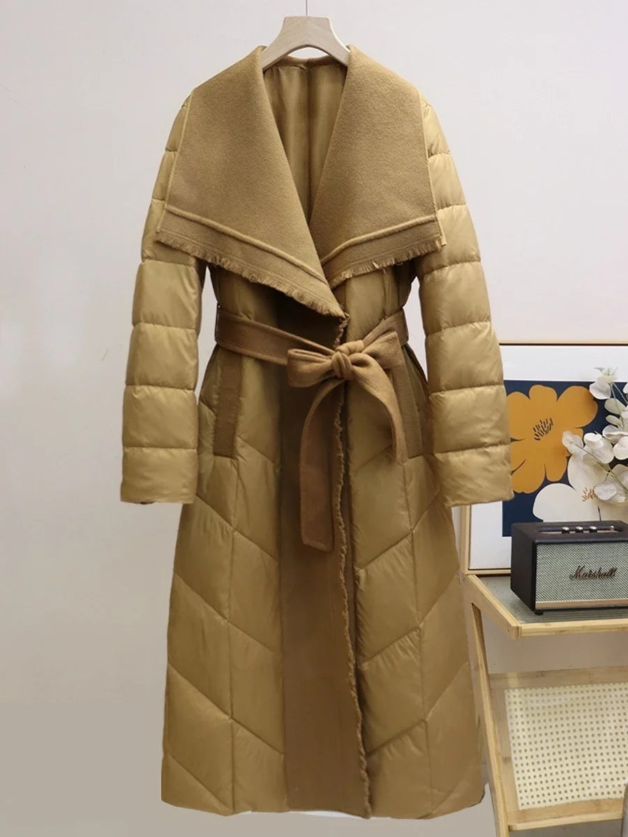 Long belted puffer jacket for women by Christine Brewer, featuring a quilted design and cozy, insulated style.