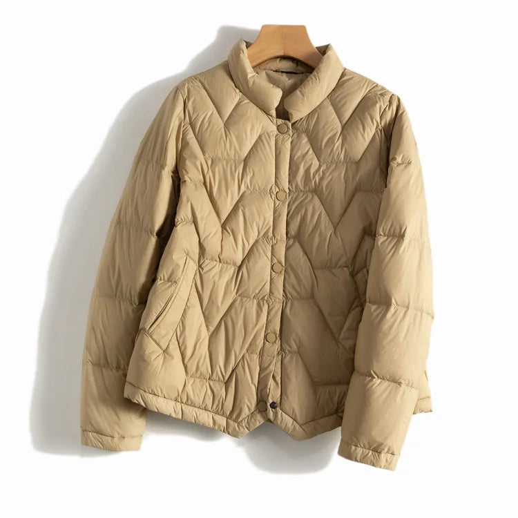 Women’s Aurora short quilted puffer jacket by Christine Brewer, featuring a stylish, insulated design with a stand collar and horizontal quilting.