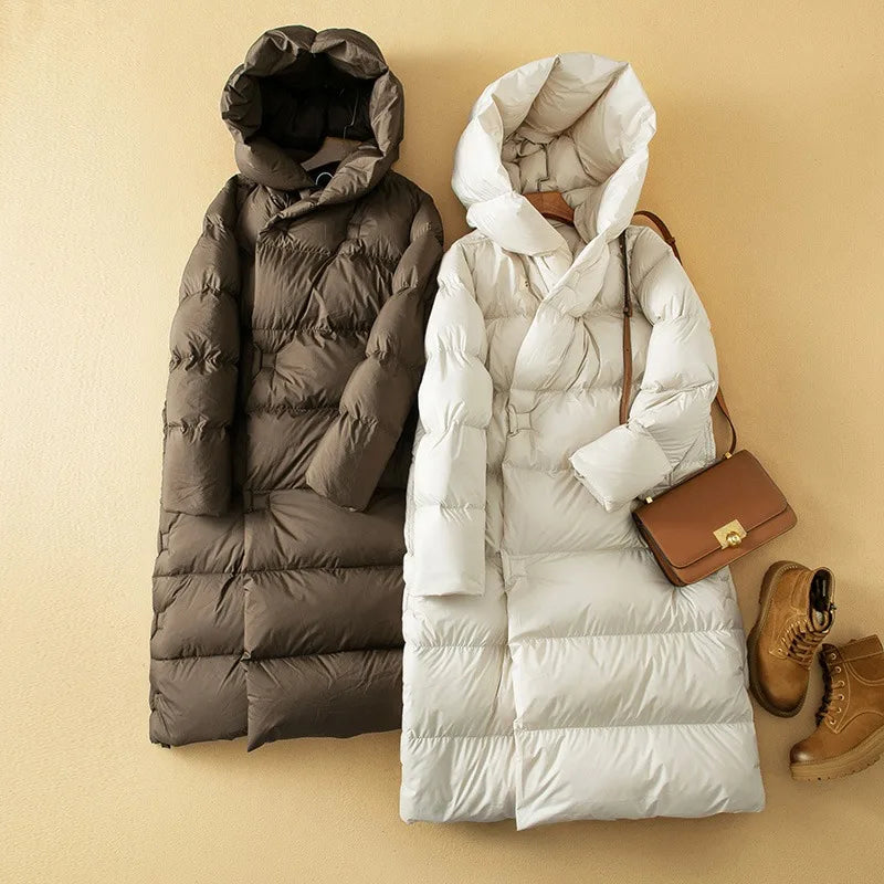 Long hooded women's parka by Christine Brewer featuring a cozy hood, stylish design, and warm, durable fabric.