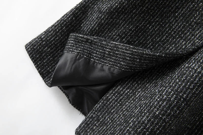 Longline tweed coat for women by Christine Brewer featuring a belted waist and classic textured fabric, styled for a sophisticated look.