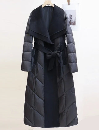 Lily long belted puffer jacket for women by Christine Brewer, featuring a quilted design, belt at waist, and hood for warmth.