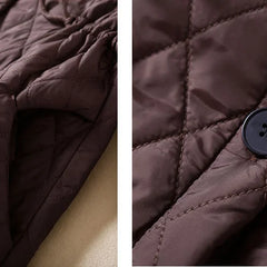 Longline puffer jacket for women by Christine Brewer, featuring a stylish, insulated design perfect for cold weather.