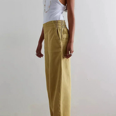 Blue denim wide-leg women's jeans by Christine Brewer, relaxed fit with classic five-pocket design and high-rise waist.