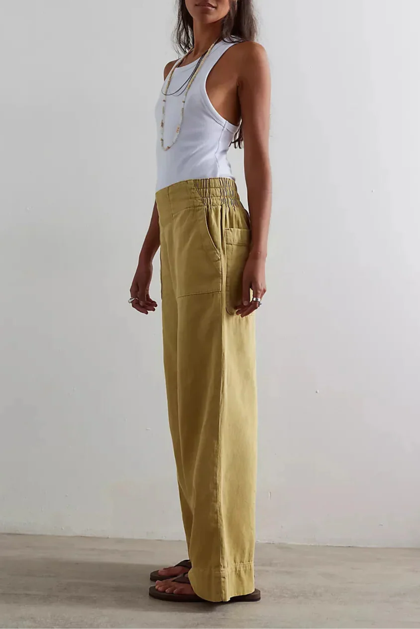 Blue denim wide-leg women's jeans by Christine Brewer, relaxed fit with classic five-pocket design and high-rise waist.