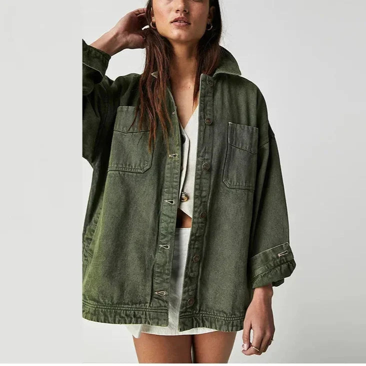 Oversized denim shirt jacket for women by Christine Brewer, featuring classic blue denim with button front and relaxed fit.
