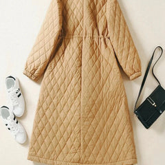Longline pink puffer jacket for women by Christine Brewer, featuring a warm, quilted design and a high collar for winter wear.