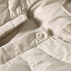 Women’s Zoe hooded quilted puffer jacket by Christine Brewer, featuring a stylish quilted design and cozy hood for cold weather.