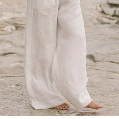 Women’s linen wide-leg trousers by Christine Brewer, loose pull-on pants with a relaxed fit and wide-leg design, shown in natural fabric.