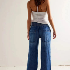 Blue denim wide-leg women's jeans by Christine Brewer, relaxed fit pants with a casual, stylish look.