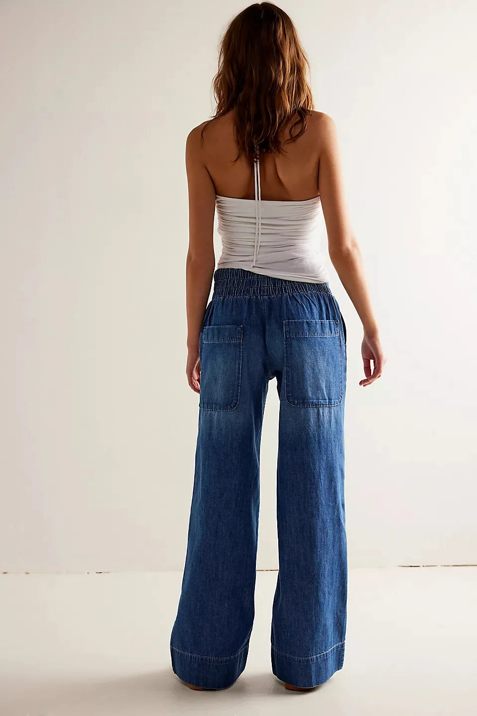 Blue denim wide-leg women's jeans by Christine Brewer, relaxed fit pants with a casual, stylish look.