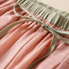 Loose tapered linen trousers for women by Christine Brewer, featuring a relaxed fit and pull-on style in natural linen fabric.