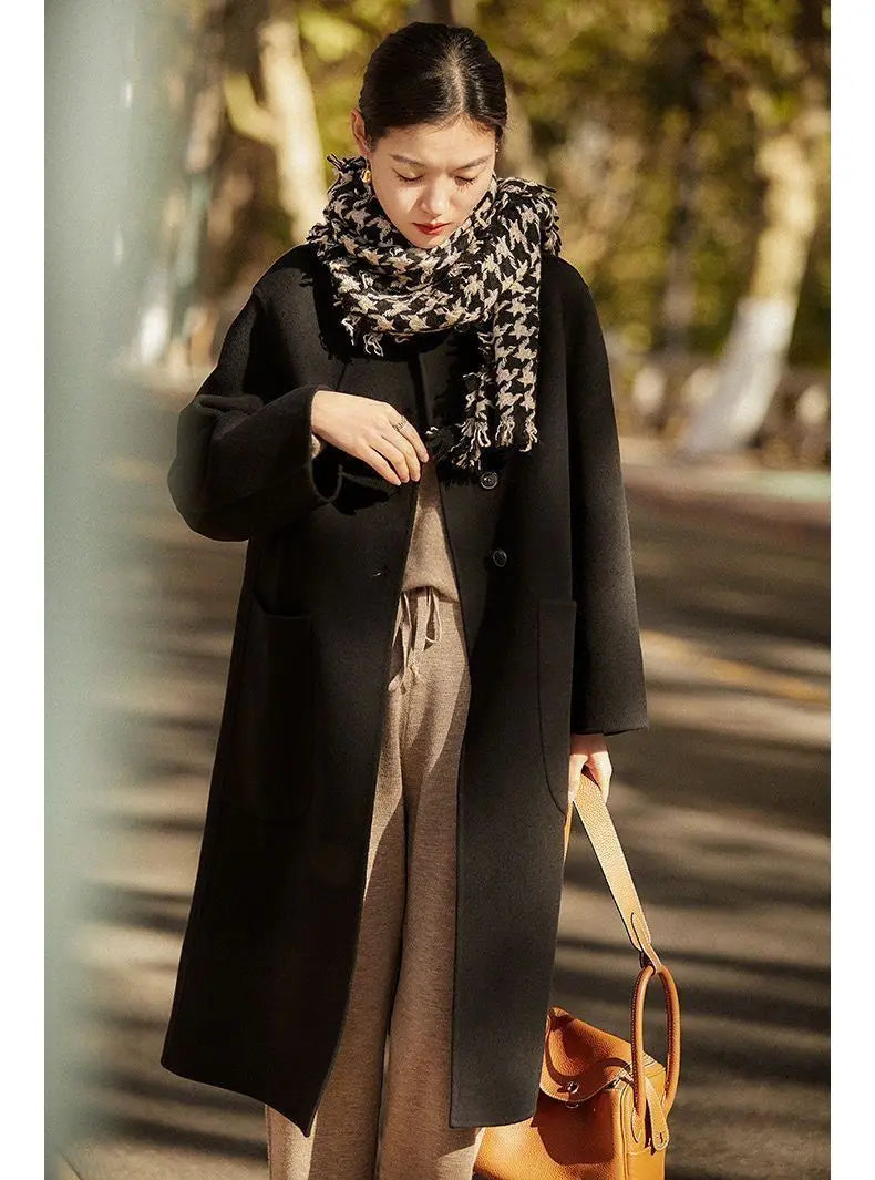 Green long wool coat for women from Christine Brewer, featuring a stylish and warm design with a classic fit.