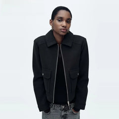 Women’s Isla cropped zip-up utility jacket by Christine Brewer, shown in dark green with multiple utility pockets and a front zipper.