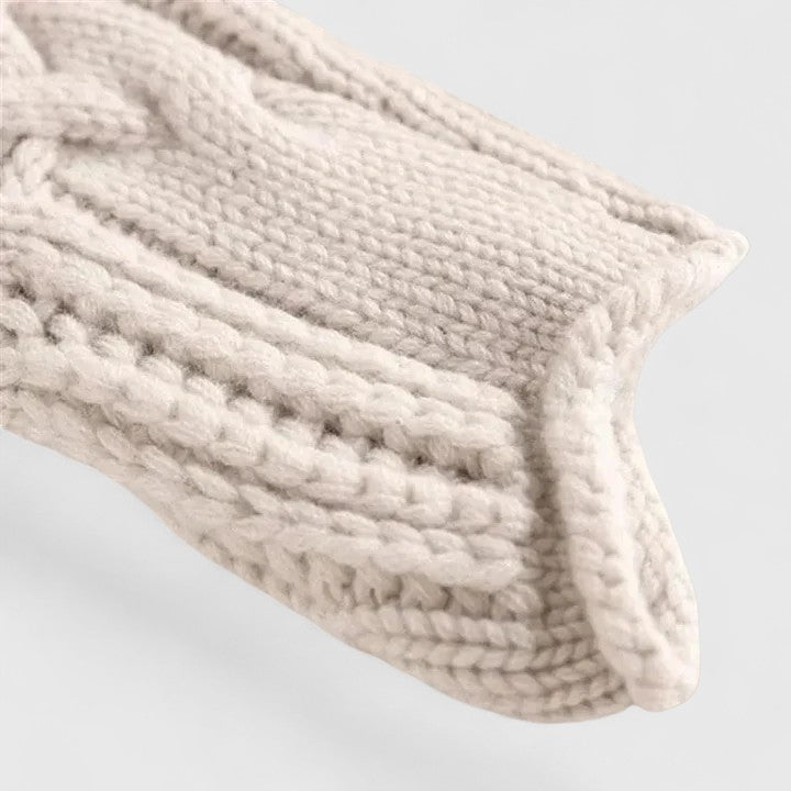 Cream-colored knit sweater for women by Christine Brewer, featuring a cozy, textured design with a round neckline.