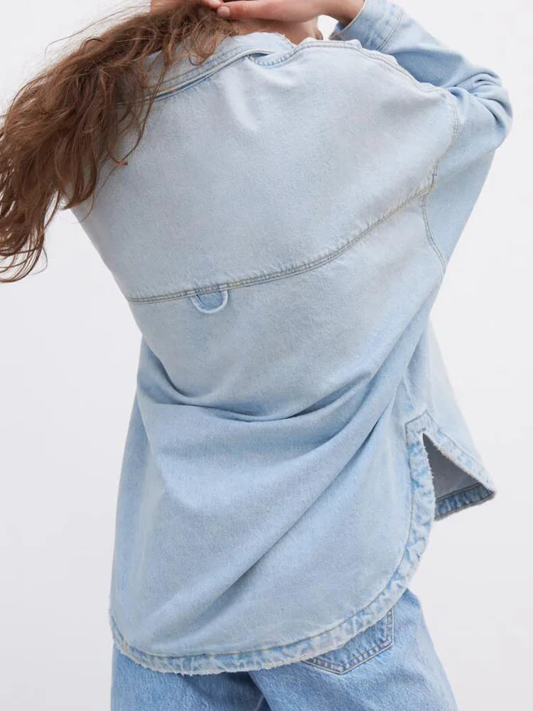 Women’s relaxed denim shirt jacket by Christine Brewer, featuring classic blue denim, button front, and casual fit.