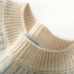 Cream-colored cashmere mock neck sweater for women by Christine Brewer, featuring a cozy, soft knit fabric and a fitted silhouette.