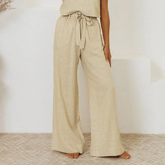 Light beige linen wide-leg trousers for women, loose pull-on style by Christine Brewer, shown on a model.