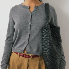 Women’s knit cardigan by Christine Brewer featuring a cozy, textured knit in a classic design with long sleeves and button closure.