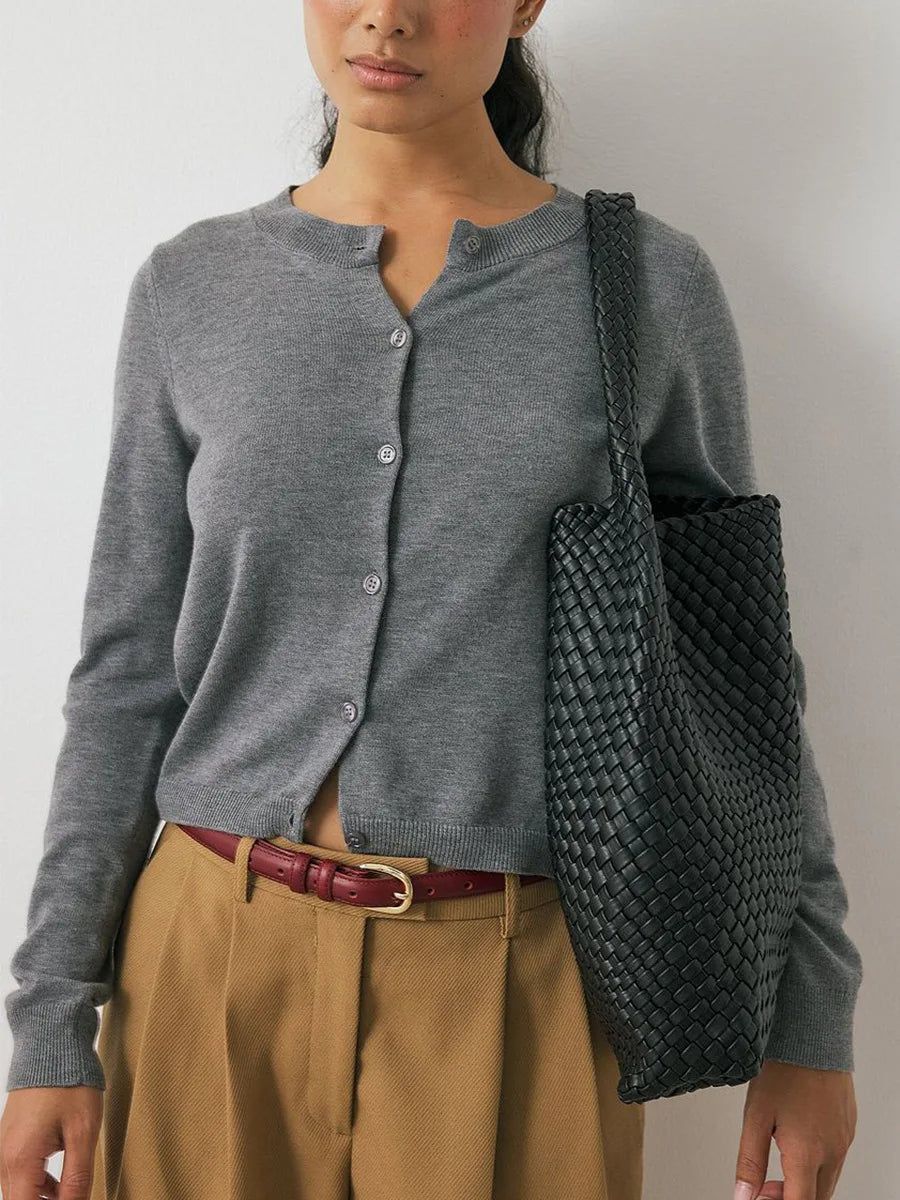 Women’s knit cardigan by Christine Brewer featuring a cozy, textured knit in a classic design with long sleeves and button closure.
