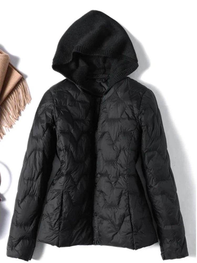 Women’s quilted puffer jacket with hood by Christine Brewer, featuring a sleek quilted design and cozy insulation.