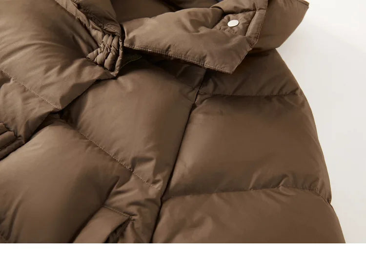 Women's cropped quilted parka by Christine Brewer, featuring a stylish, insulated design with a high collar and quilted pattern.
