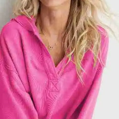Pink Eleanor cropped hoodie for women by Christine Brewer, featuring a relaxed fit and soft fabric, shown on a model.