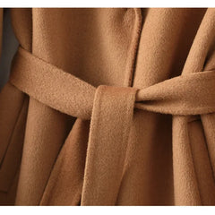 Olivia long belted wool coat for women by Christine Brewer, shown in a stylish view highlighting the coat’s tailored fit and belt detail.