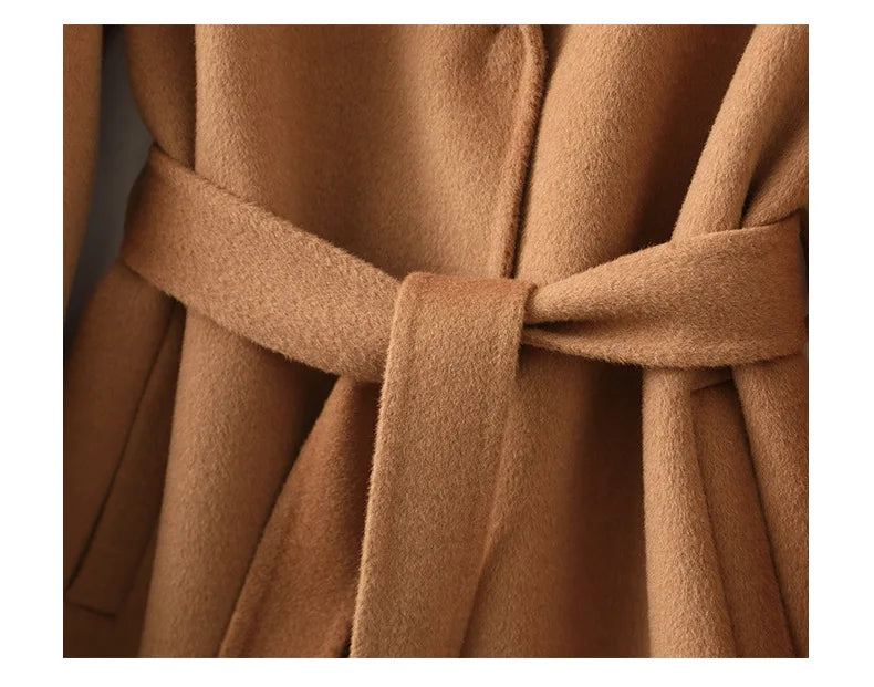 Olivia long belted wool coat for women by Christine Brewer, shown in a stylish view highlighting the coat’s tailored fit and belt detail.