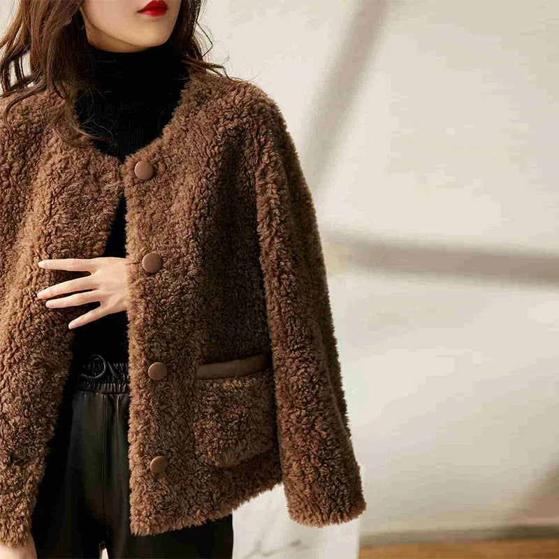 Elegant Emily faux fur coat for women by Christine Brewer, showcasing plush beige faux fur with wide collar and stylish design.