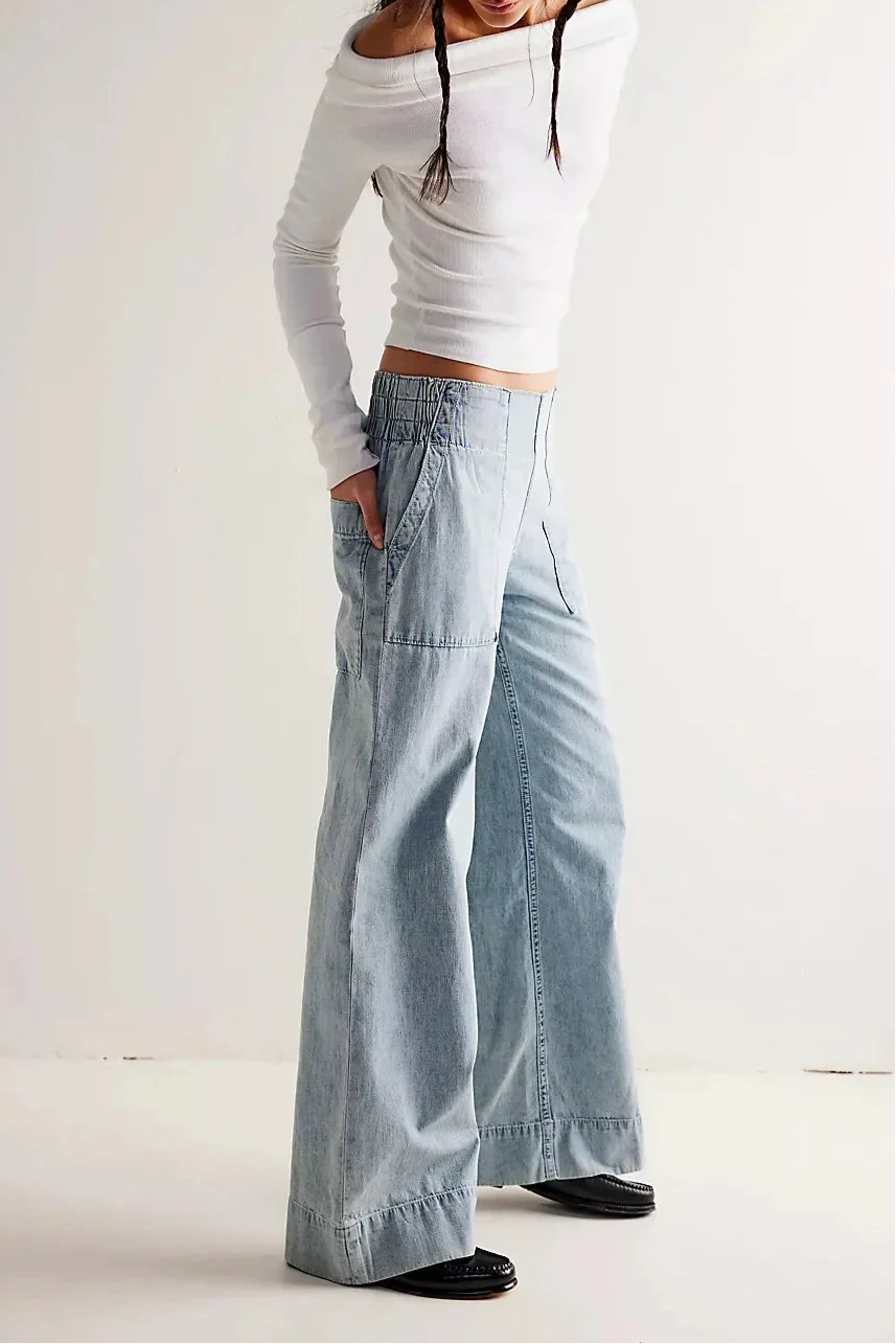 Blue denim wide-leg women's jeans by Christine Brewer, relaxed fit pants with a casual, stylish look.