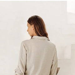 Light beige linen wide-leg women's trousers by Christine Brewer, loose pull-on style, flowing and comfortable fit.