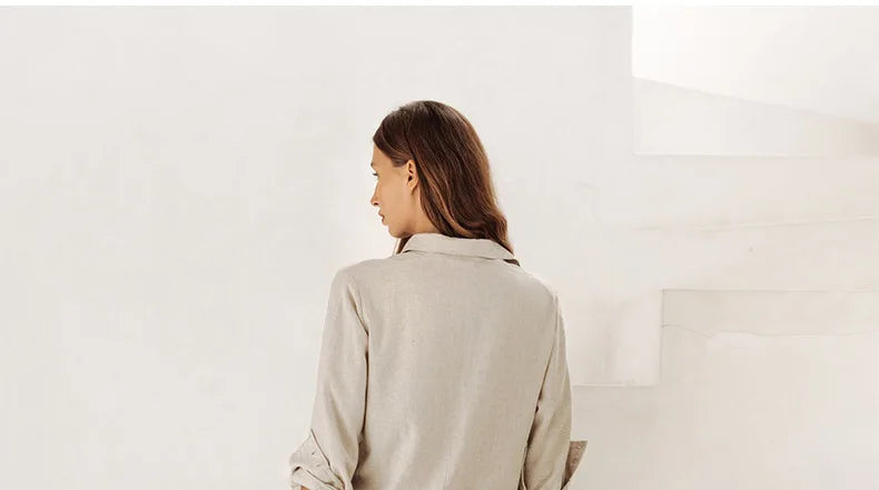 Light beige linen wide-leg women's trousers by Christine Brewer, loose pull-on style, flowing and comfortable fit.