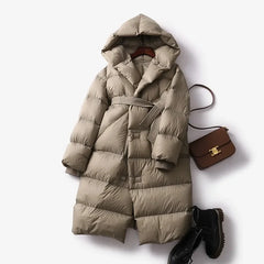 Ella long belted puffer jacket for women by Christine Brewer, showcasing a stylish quilted winter coat with belt and high collar.