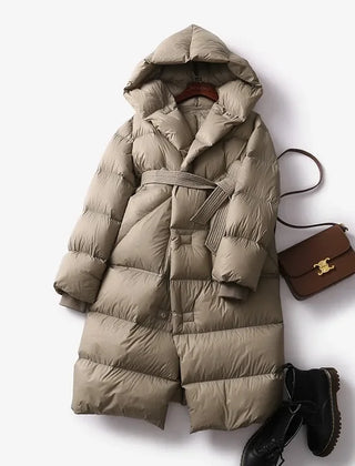 Ella long belted puffer jacket for women by Christine Brewer, showcasing a stylish quilted winter coat with belt and high collar.