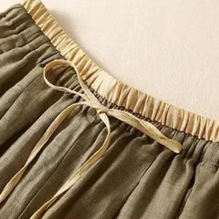 Light beige tapered linen trousers for women by Christine Brewer, loose pull-on style, casual and comfortable fit.
