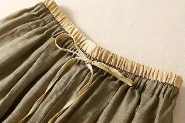 Light beige tapered linen trousers for women by Christine Brewer, loose pull-on style, casual and comfortable fit.
