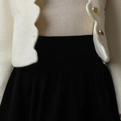 Everleigh cropped button-front women's jacket by Christine Brewer, shown in black with long sleeves and stylish front buttons.