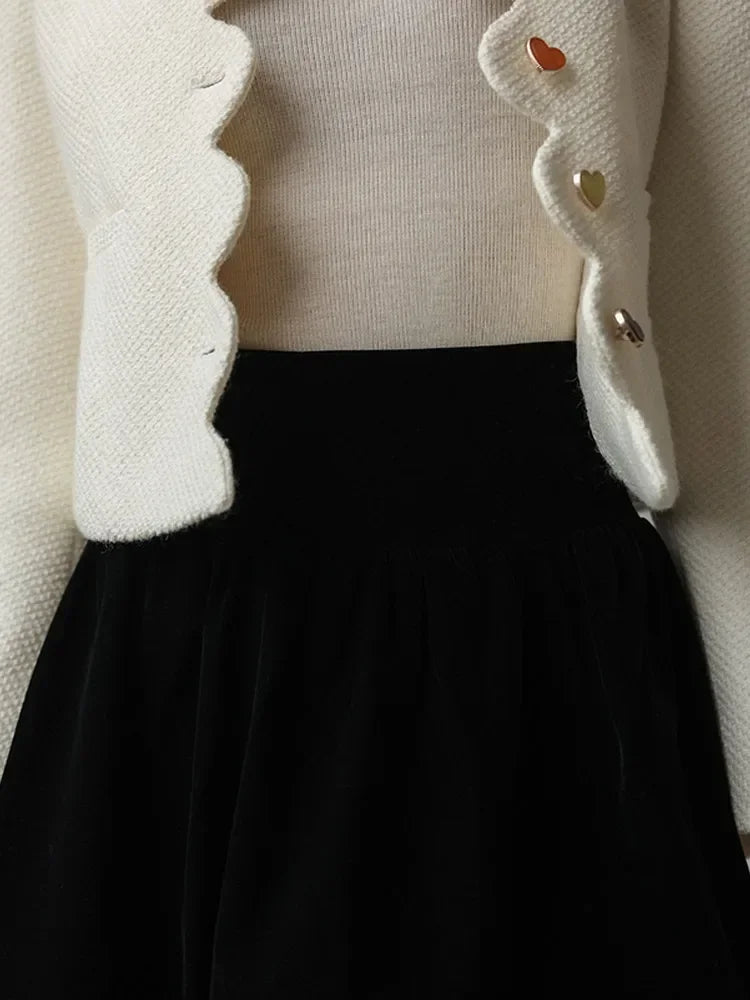 Everleigh cropped button-front women's jacket by Christine Brewer, shown in black with long sleeves and stylish front buttons.