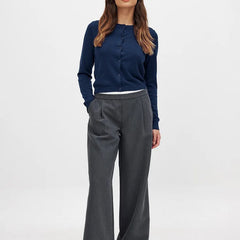 Woman wearing the Christine Brewer Finley knit cardigan, featuring a cozy, button-up design in a soft, neutral color.