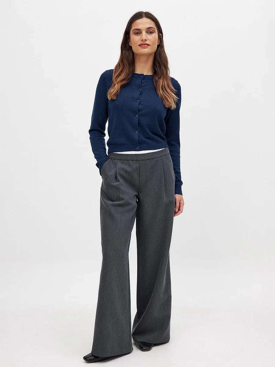 Woman wearing the Christine Brewer Finley knit cardigan, featuring a cozy, button-up design in a soft, neutral color.