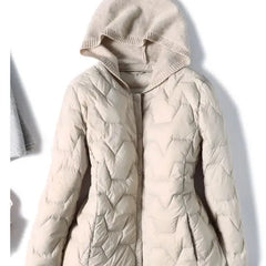 Women’s hooded quilted puffer jacket by Christine Brewer, featuring a stylish design and insulated warmth.