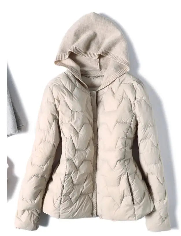 Women’s hooded quilted puffer jacket by Christine Brewer, featuring a stylish design and insulated warmth.