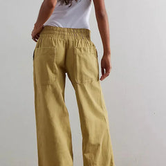 Blue denim wide-leg women's jeans by Christine Brewer, relaxed fit pants with a trendy, flowy silhouette.